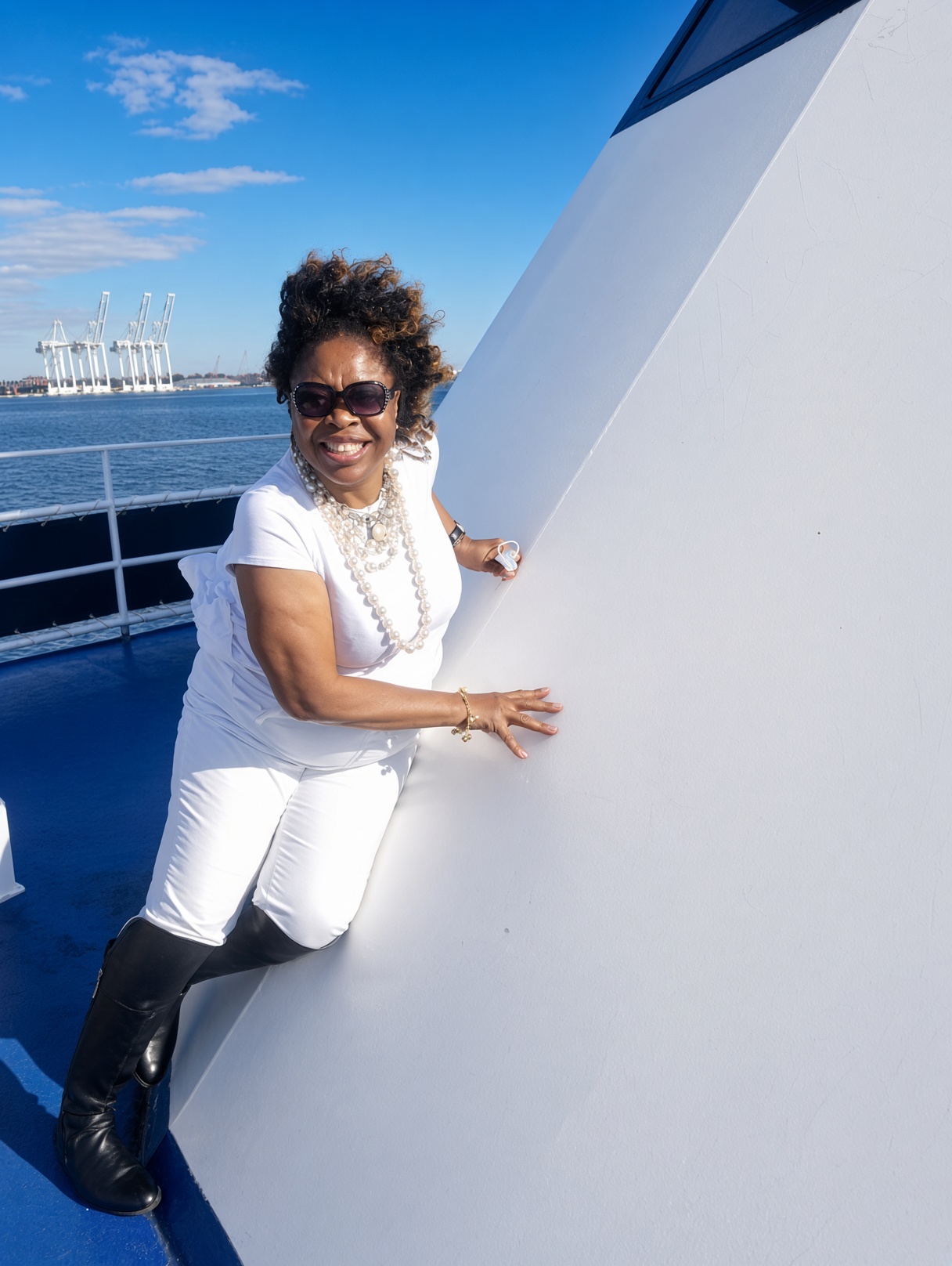 Evangelist Gloria Nzenwa smiling on a boat in white